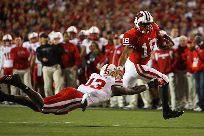 Oct 1, 2011; Madison, WI, USA; Wisconsin Badgers quarterback Russell Wilson (16) scores a touchdown as Nebraska Cornhuskers safety P.J. Smith (13) attempts a tackle during the third quarter at Camp Randall Stadium. Mandatory Credit: Brace Hemmelgarn-USA TODAY Sports